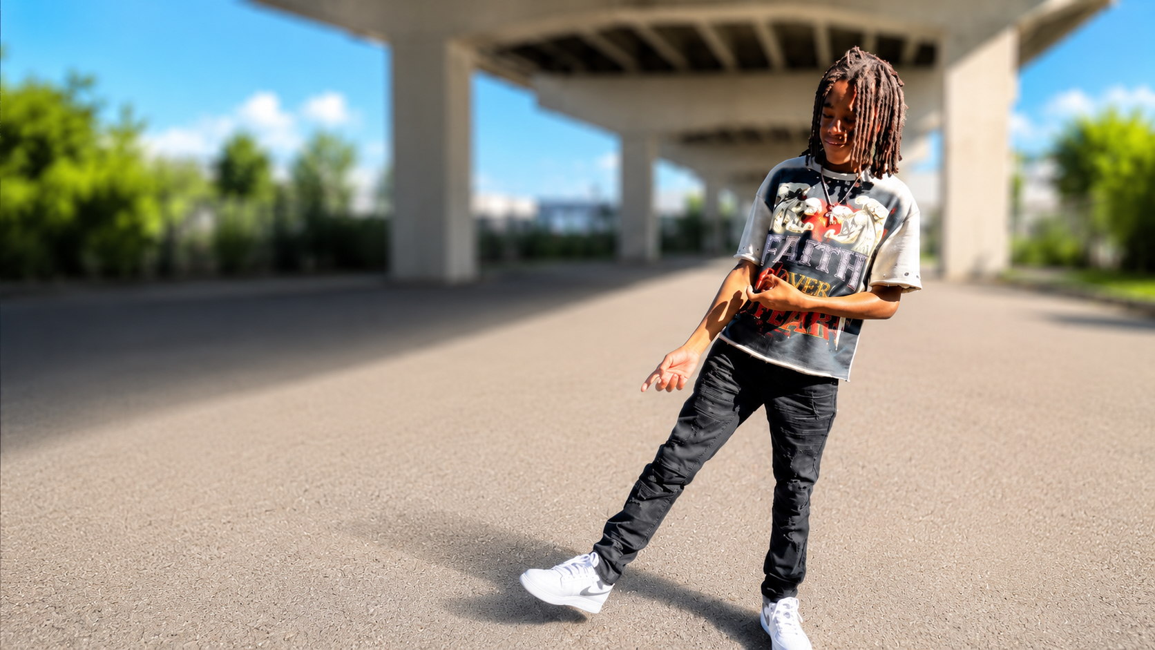 Aiden Hundley standing under the overpass — Coming Soon